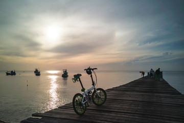 Fototapeta premium Sunset View of Old Wooden Jetty by the sea at Thap Sakae, Prachuap Khiri Khan, Thailand