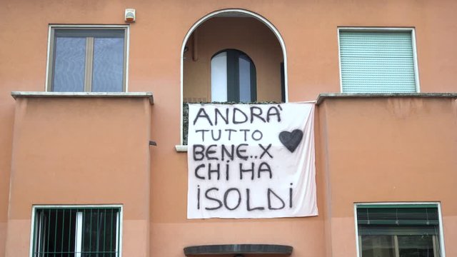 Europe,Italy, Milan March 2020, Coronavirus emergency - windows of the city hang sheets designed by children with rainbow and the words "everything will be fine" ( Tutto Andra' bene )  for rich people