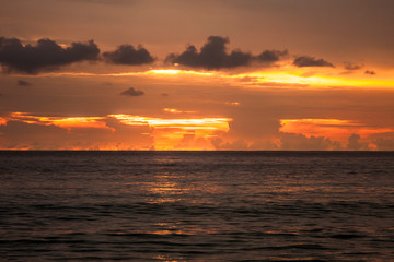 Fiery sky at sunset over the sea in Thailand