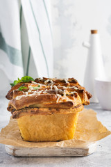 Pull-apart bread with Italian pasta pesto, basil and parmesan cheese in baking form over old light...