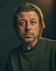 Fototapeta premium Middle aged man with stubble beard in green sweater.