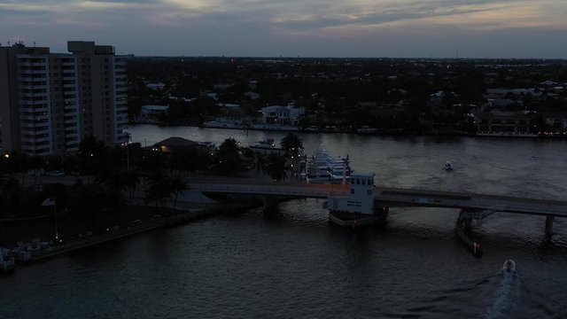 Panoramic aerial reveal, gorgeous sunset reflecting off the dark waters of Hillsboro inlet, Pampano Beach Florida