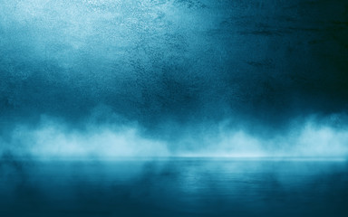 Dark blue wall with decorative stucco. Smoke, smog, spotlight