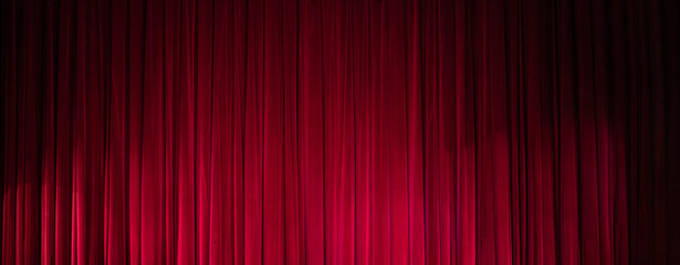 Theatrical dark red velvet curtain. Texture background for design.