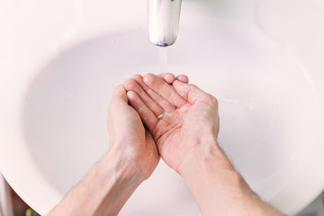 Man use soap and washing hands under the water tap. Hygiene conc