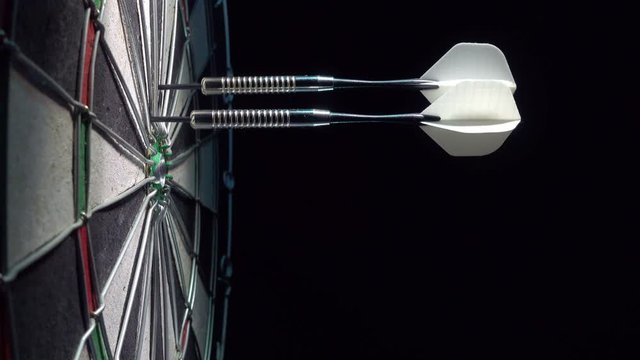 Throw three dart arrows at the dartboard.