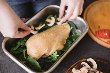 Diet concept, healthy lifestyle, low calorie food. Closeup portrait of woman cooking healthy dinner of chicken meat and mushrooms