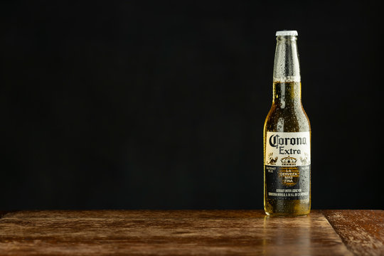 MUNICH, GERMANY – MARCH 11, 2020: A bottle of corona beer on a counter. With the rise of corona virus Americans do consume 34% less Corona beer. Selective focus