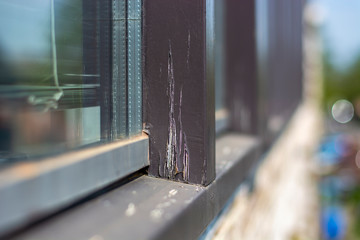 Damaged cracked modern residential window frames in bad condition with peeling paint that need to...