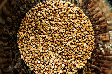 Buckwheat grits background. Buckwheat grains. Buckwheat circle. Buckwheat porridge scatter.