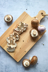 Fresh royal champignon mushrooms on a wooden board. View from above