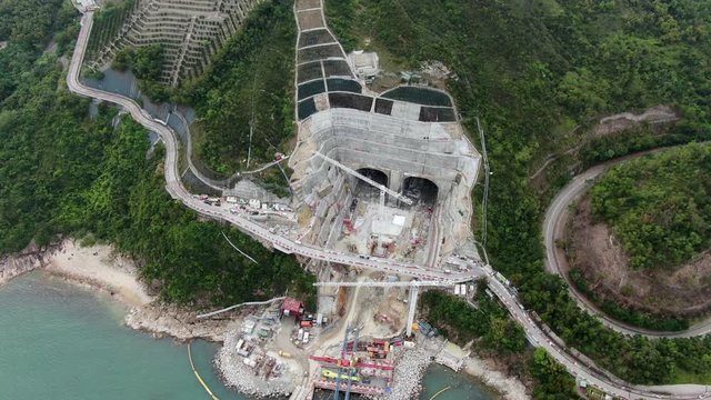 Aerial view of a mega scale tunnel road construction sire in Hong Kong bay.