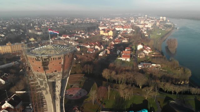 Panorama of the war torn water tower on the edge of the Danube River Vukovar Croatia, Aerial slide left