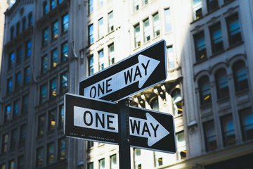 'One way' road signs on the wall of building in New York.