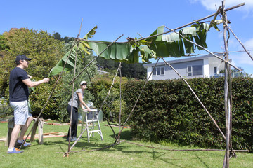 Jewish Couple Building a Sukkah on Sukkoth Feast of Tabernacles Jewish Holiday