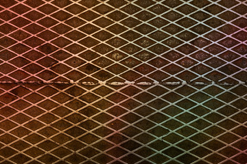Rainbow colored patina on a old vintage diamond textured metal surface sheet background