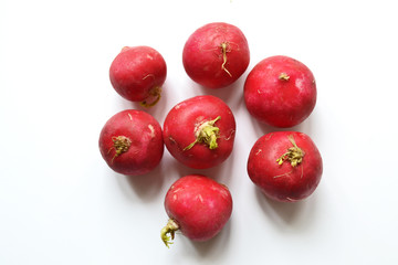 A bunch of fresh radishes on white with soft shadow.