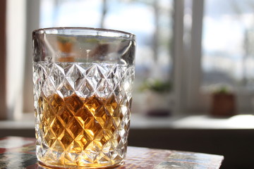 glass of alcohol cognac rum on a light background