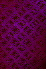 Colorful neon diamond textured steel background. Deep pink purple colors with a color changing effect. Vertical shot, Wallpaper style. Decoration