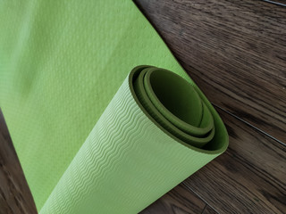 Yoga mat in green. Equipment for yoga. Healthy lifestyle concept