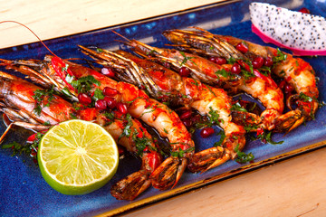 large prawns with lemon on a plate