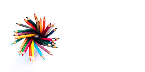 Colored pencils in a glass on a white background. The view from the top. Copy space
