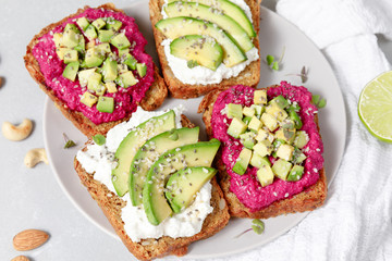 Variation of rye bread sandwiches with avocado beetroot and cream cheese