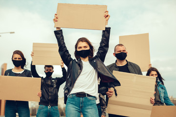 A group of people with mask and posters to protest The protest of the population against coronavirus and against the introduction of quarantine Meeting about coronavirus and people rights. copyspace