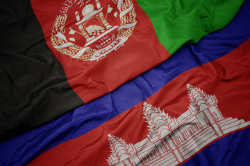 waving colorful flag of cambodia and national flag of afghanistan.