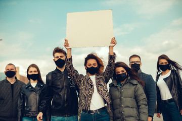 A group of people with mask and posters to protest The protest of the population against...