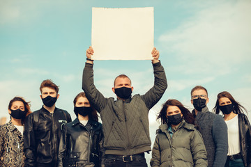 A group of people with mask and posters to protest The protest of the population against...