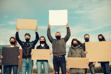 A group of people with mask and posters to protest The protest of the population against...