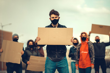 A group of people with mask and posters to protest The protest of the population against...