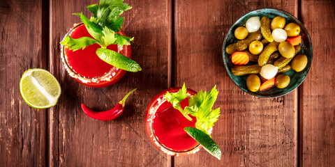 Bloody Mary cocktail panorama, tomato juice, lime, and celery, shot from the top on a rustic...