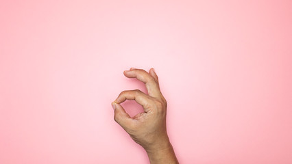 Male hand Ok symbol isolated on pink background, Blank for design copy space..