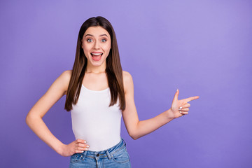 Photo of pretty attractive lady direct finger side empty space advising novelty open mouth low shopping prices wear white tank-top jeans isolated pastel purple color background