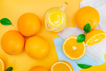 Orange juice with oranges on yellow background