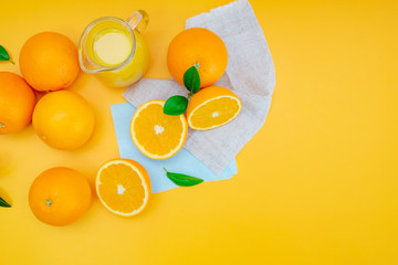 Orange juice with oranges on yellow background