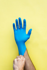 Hand with a blue sterilised medical glove