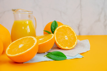 Orange juice with oranges on yellow background