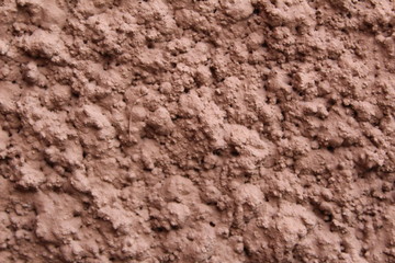 wall with a modern coating of brown clay plaster