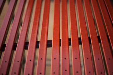 Painted metal profile. Steel in brown paint. Work in the workshop. Sliced steel square pipes. Creating a design. Preparatory actions. Natural light. Saturated colors. Neatly done.