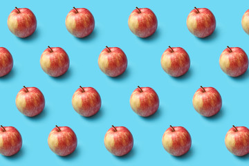 Fresh natural organic apples pattern on a blue background.