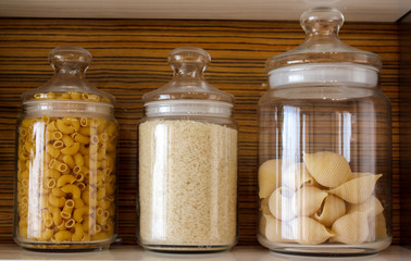 A set of transparent glass bottles. Realistic banks. Labeled cans for dairy products