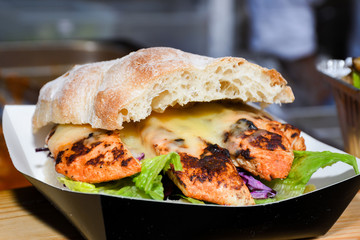 Fresh melting burger ready to eat during fast food festival.