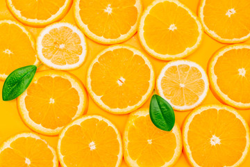 Orange slices on yellow background