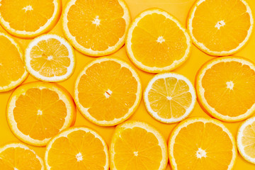 Orange slices on yellow background