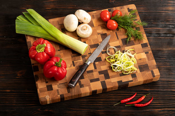 vegetables and spices on a wooden cutting board