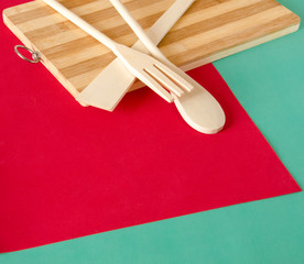 Eco-friendly wooden kitchen ware. a spoon, a fork, a shovel, a cutting board from natural material.