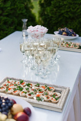 A buffet table at the wedding. Glasses of sparkling wine
